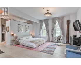 A bedroom with a large bed and a television.