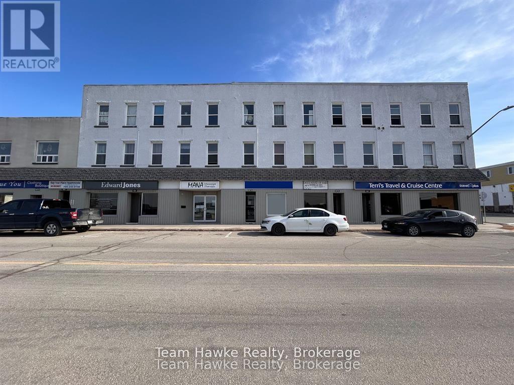 A building with the sign Team Hawke Realty Brokerage in front of it.