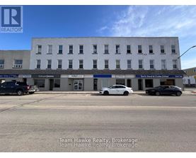 A building with the sign Team Hawke Realty Brokerage in front of it.