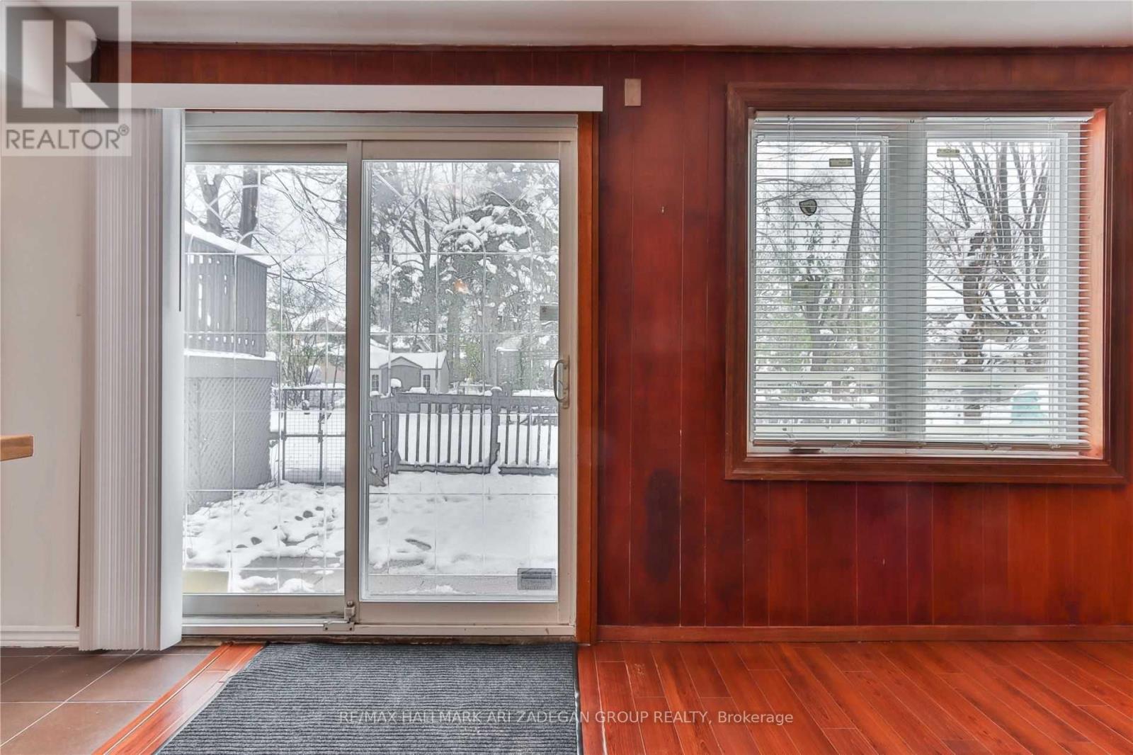 A room with a sliding glass door leading to a snowy backyard.