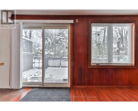 A room with a sliding glass door leading to a snowy backyard.