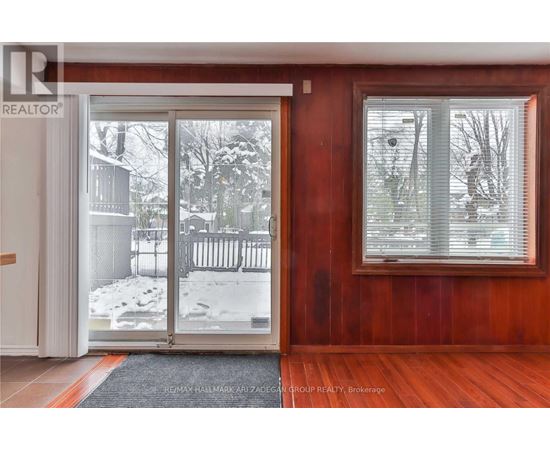 A room with a sliding glass door leading to a snowy backyard.