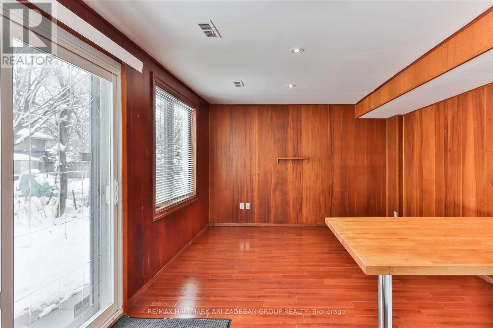 A room with wooden walls and a table.