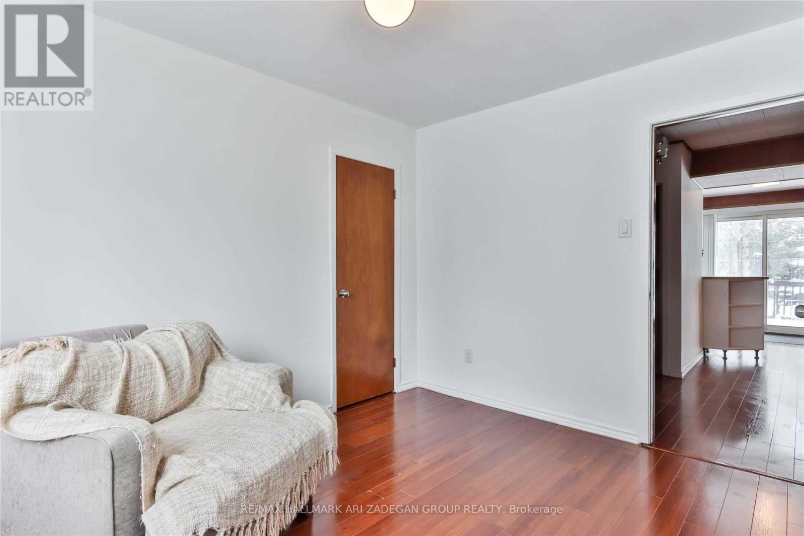 A living room with a couch and a door.