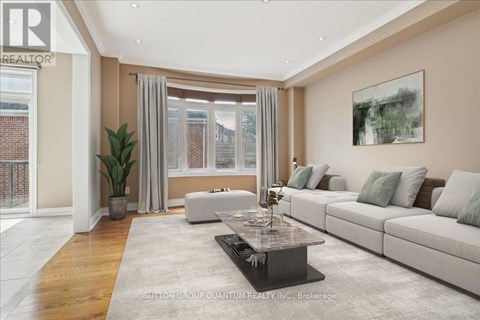 A living room with a large couch, a coffee table, and a painting on the wall.