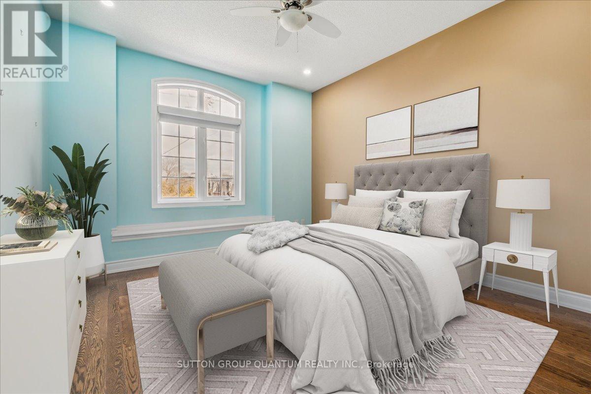 A bedroom with a large bed and a ceiling fan.