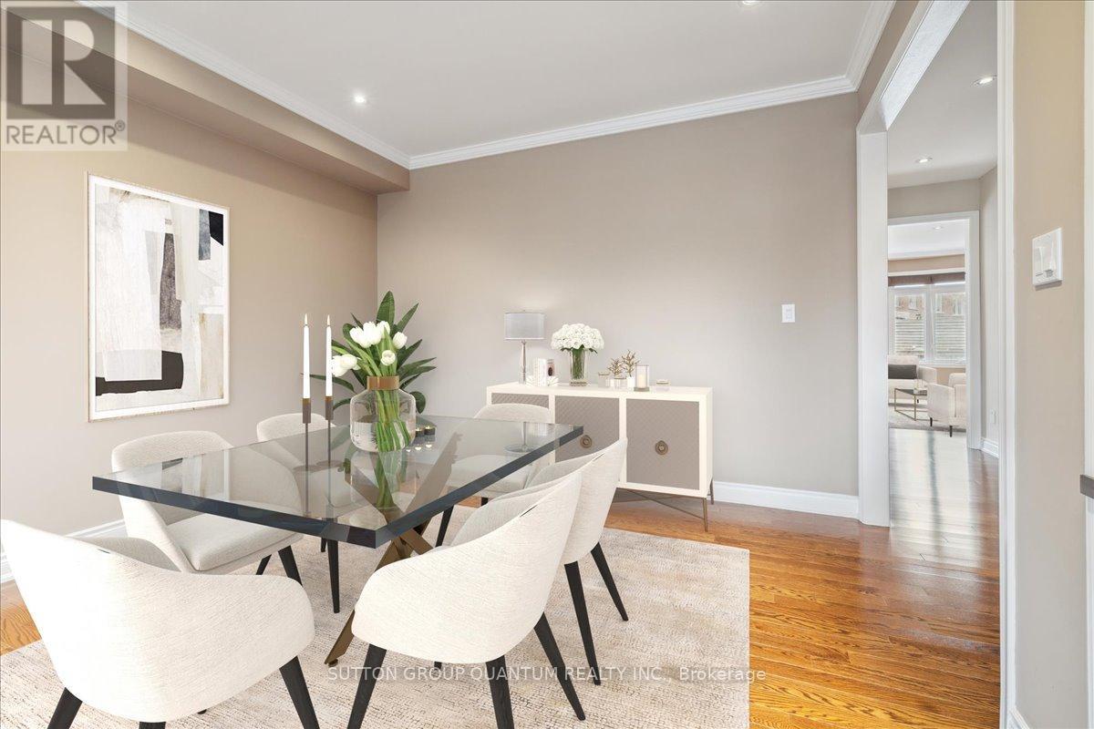 A dining room with a glass table and white chairs.