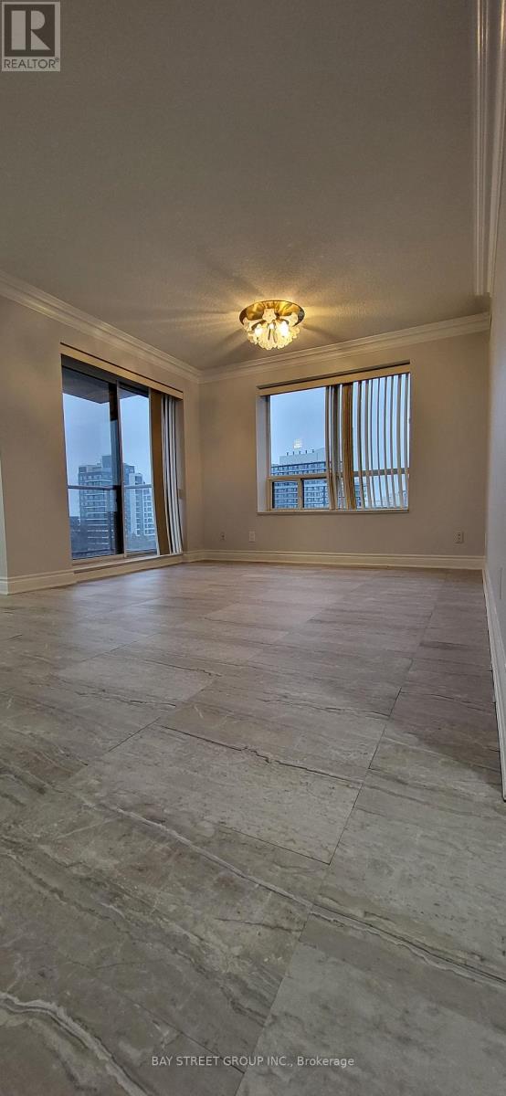 A spacious room with a large window and a marble floor.