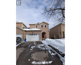 A house with a garage and a car parked in front.