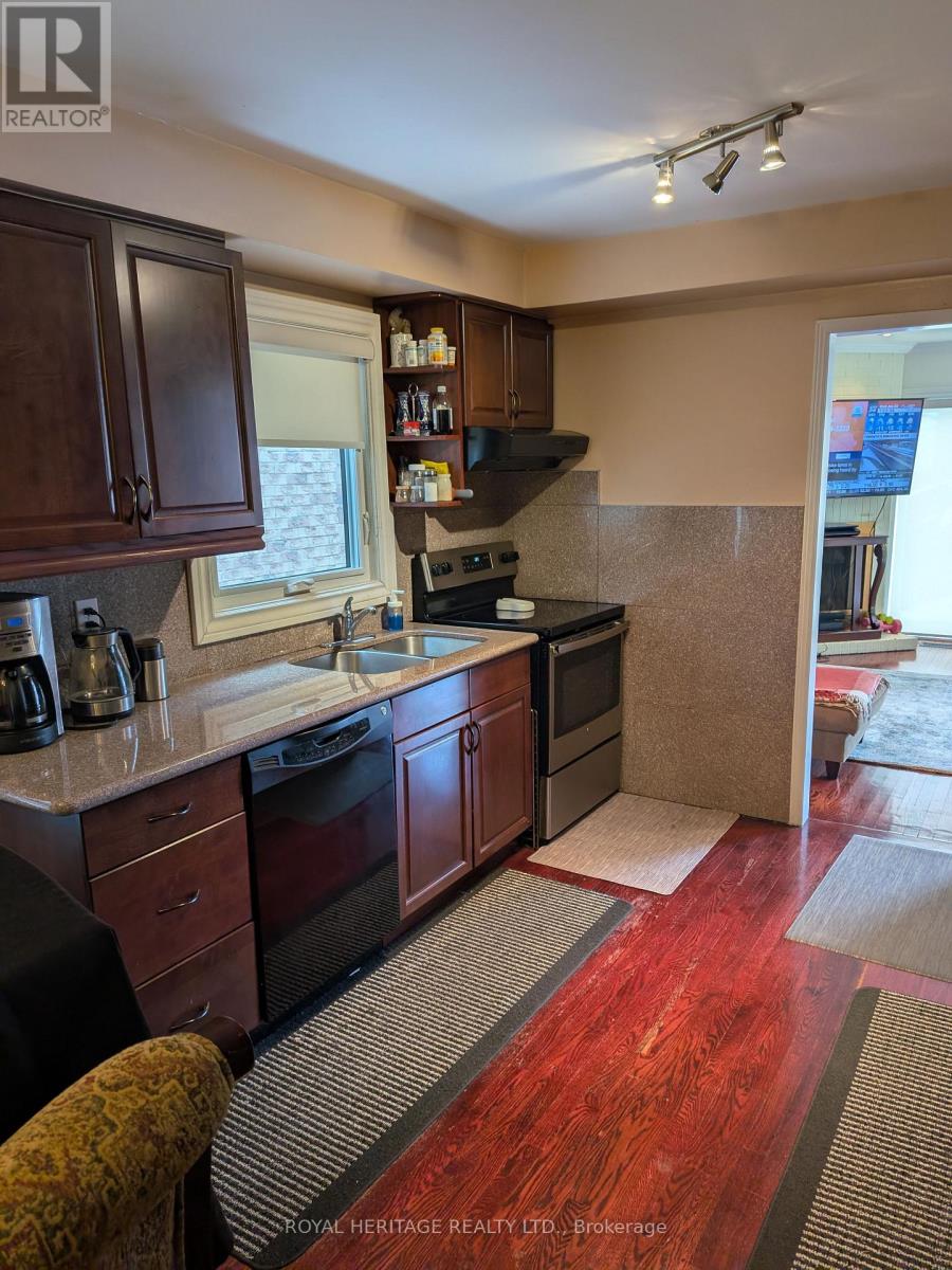 A kitchen with wooden cabinets and a red floor.