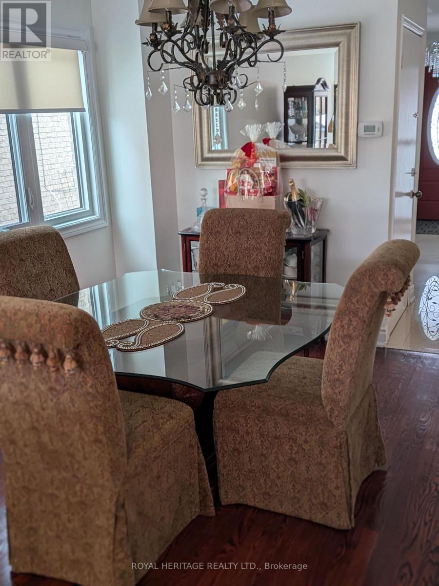 A dining room with a glass table and chairs.