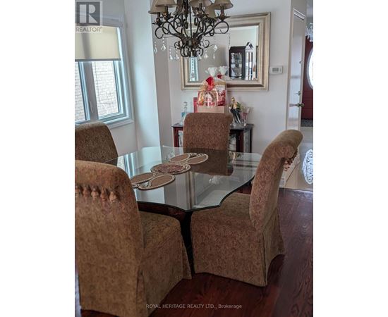 A dining room with a glass table and chairs.