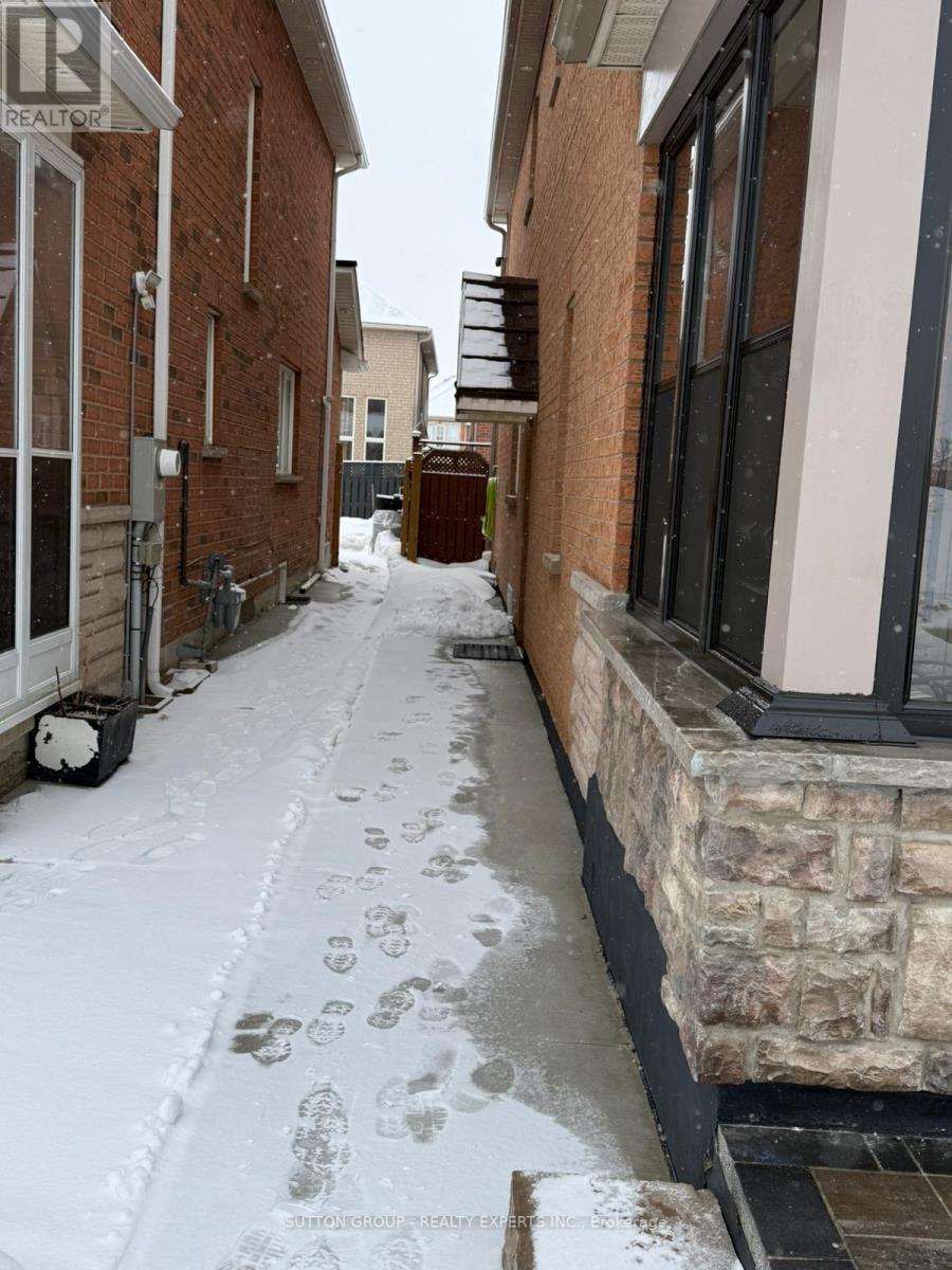 A snowy alley with footprints in the snow.