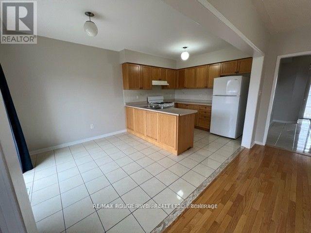 A kitchen with wooden cabinets and a white refrigerator.