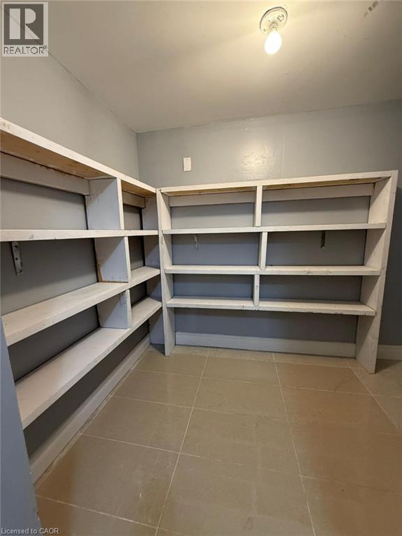 Empty shelves in a room with tiled flooring.