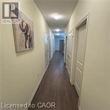 A long hallway with a painting of a horse on the wall.