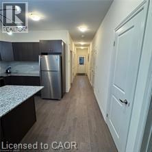 A kitchen with a refrigerator and a counter top.
