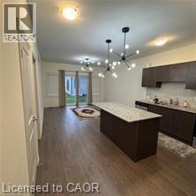 A kitchen with a large island and a ceiling fan.