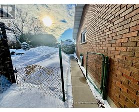 A snowy scene with a sun shining through the clouds.