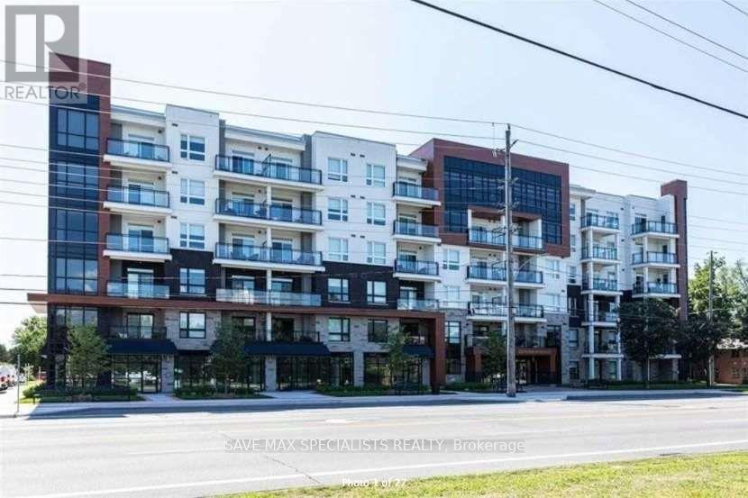 A multi-story apartment building with balconies and a sign that reads "REALTOR".