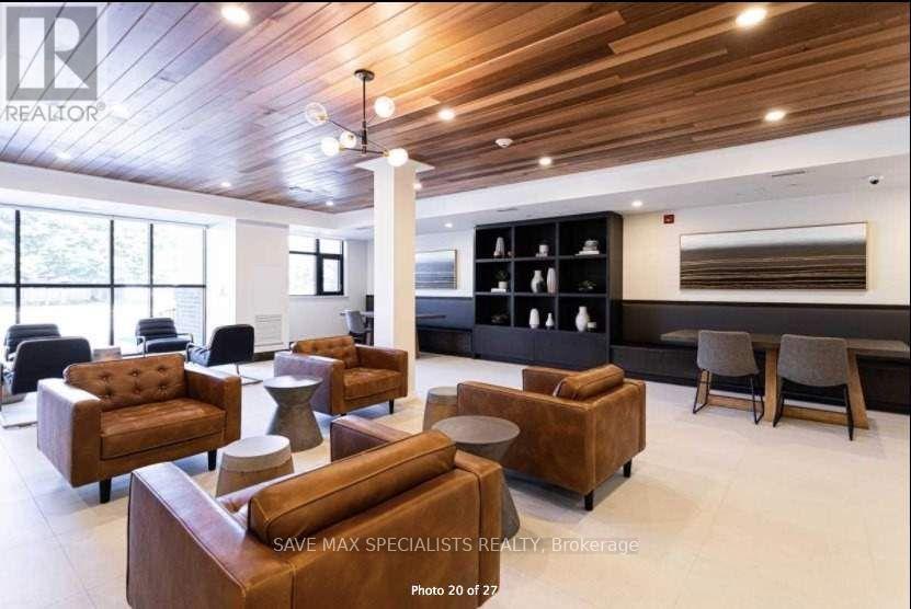A realtor's office with brown leather furniture and a wooden ceiling.