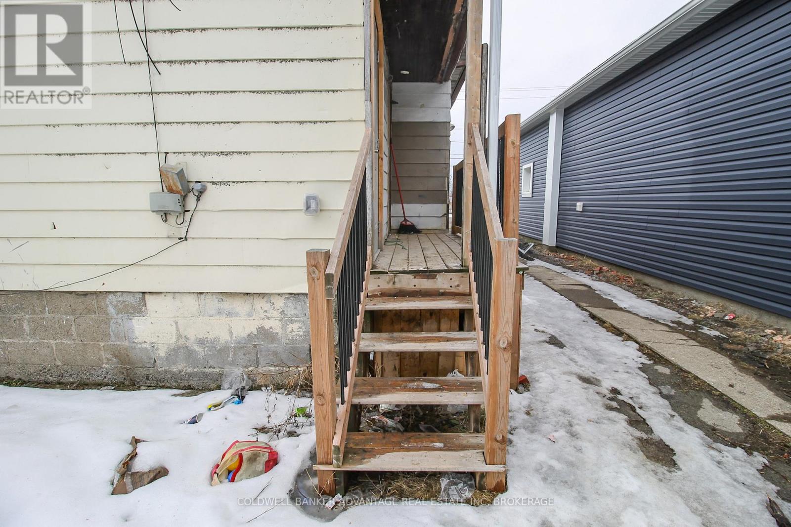 A wooden staircase leading to a garage door.