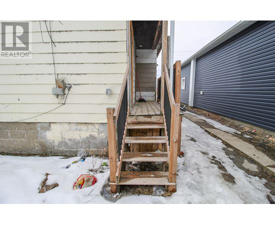 A wooden staircase leading to a garage door.