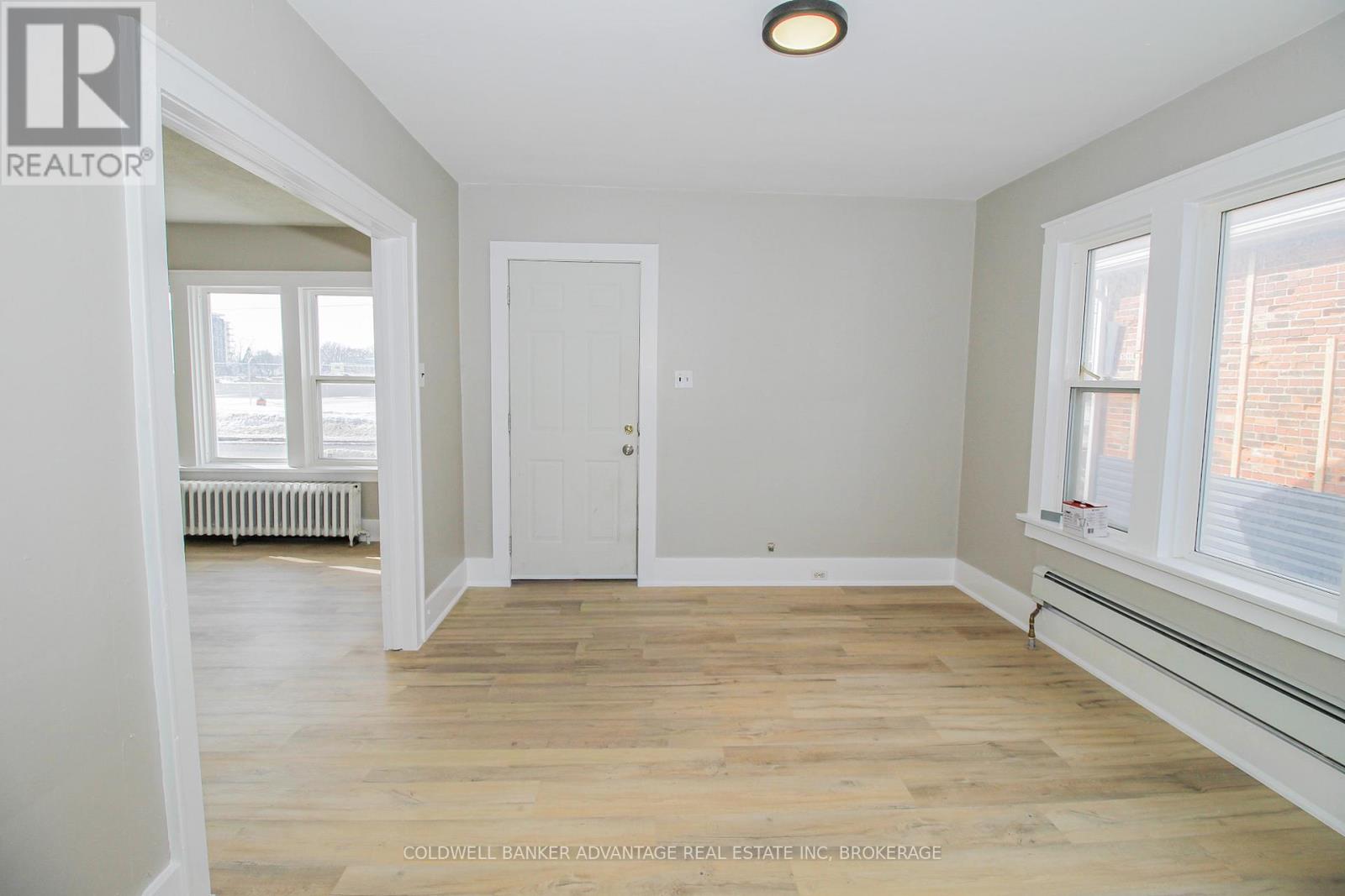 A room with a white door and a window with a white frame.