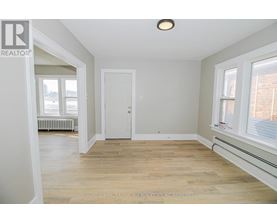 A room with a white door and a window with a white frame.