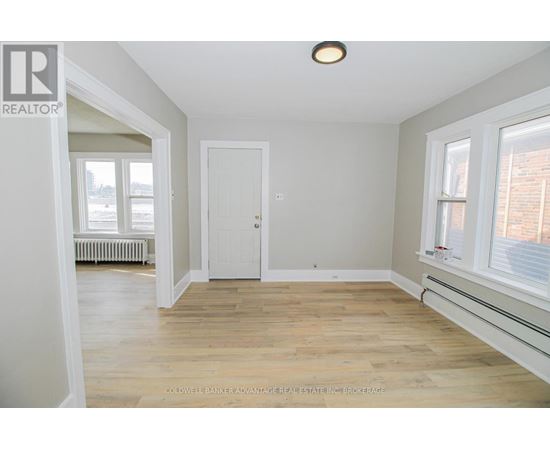 A room with a white door and a window with a white frame.