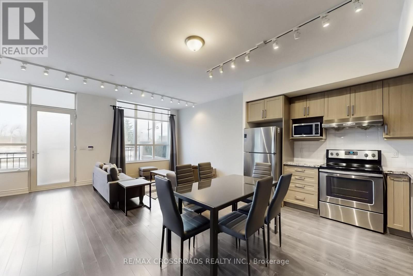 A modern kitchen with a dining table and chairs.