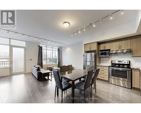 A modern kitchen with a dining table and chairs.