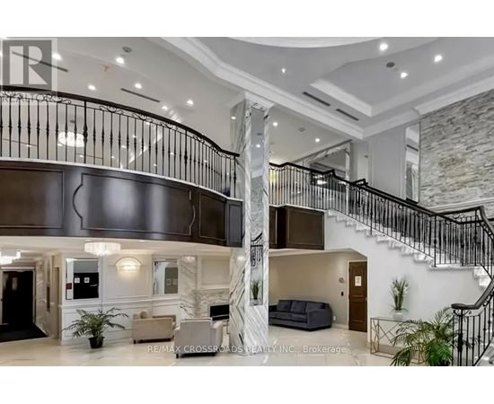 A spacious interior of a building with a staircase and a reception area.