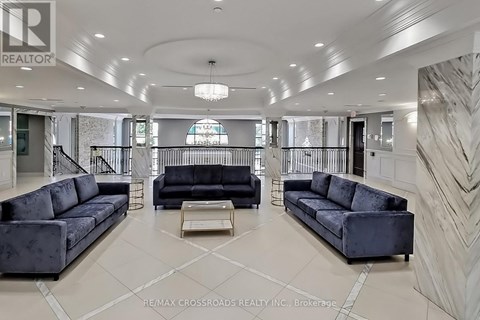 A spacious living room with a black sofa and a coffee table.