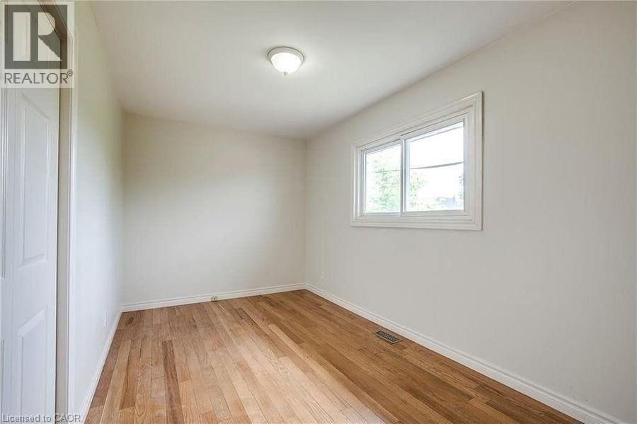 A room with wooden flooring and a window.