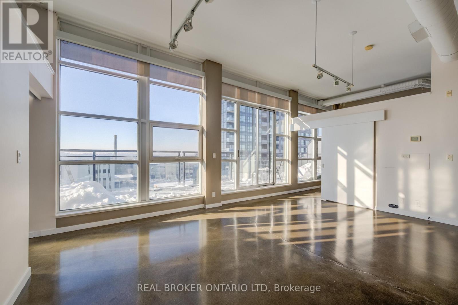 A spacious room with large windows and a view of the outside.
