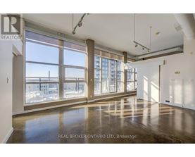 A spacious room with large windows and a view of the outside.