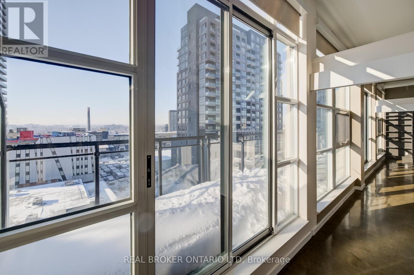 A view of a snowy landscape from a window in a building.