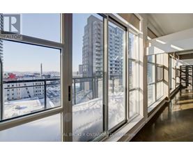 A view of a snowy landscape from a window in a building.