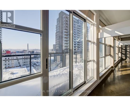 A view of a snowy landscape from a window in a building.