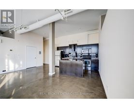 A spacious kitchen with stainless steel appliances and a large island.