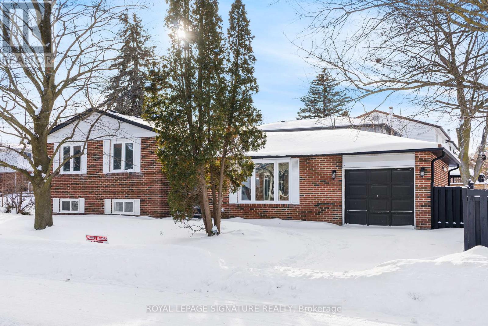 A house with a red sign in front of it is for sale.