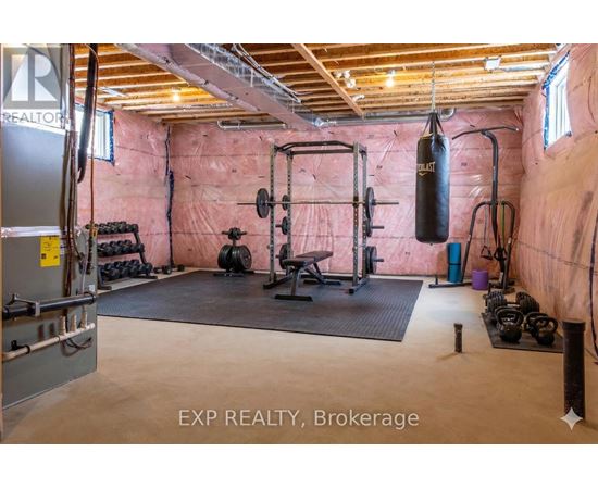 A gym with a punching bag, weights, and exercise equipment.