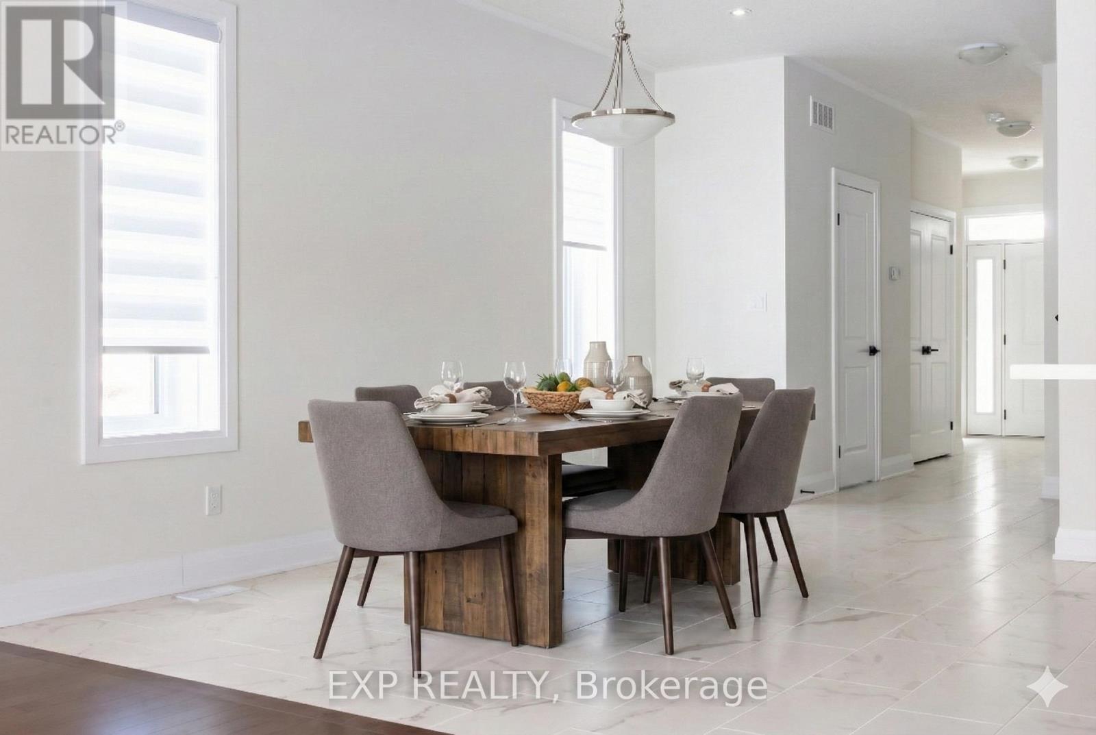 A dining room with a table set for four.