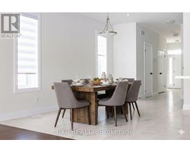 A dining room with a table set for four.