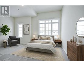 A bedroom with a large bed, a chair, and a plant.