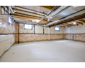 A spacious basement with insulation and pipes.