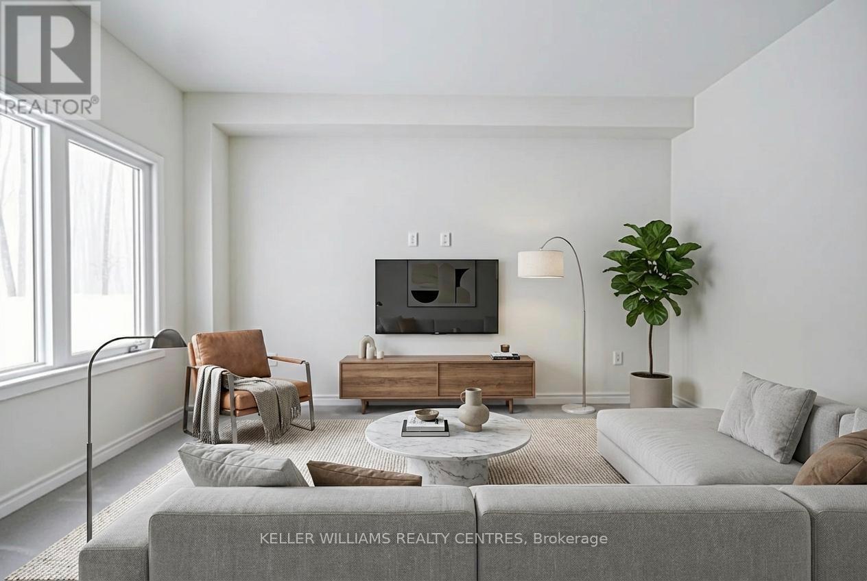 A living room with a grey couch, a wooden coffee table, a flat screen TV, a potted plant, and a window with white curtains.