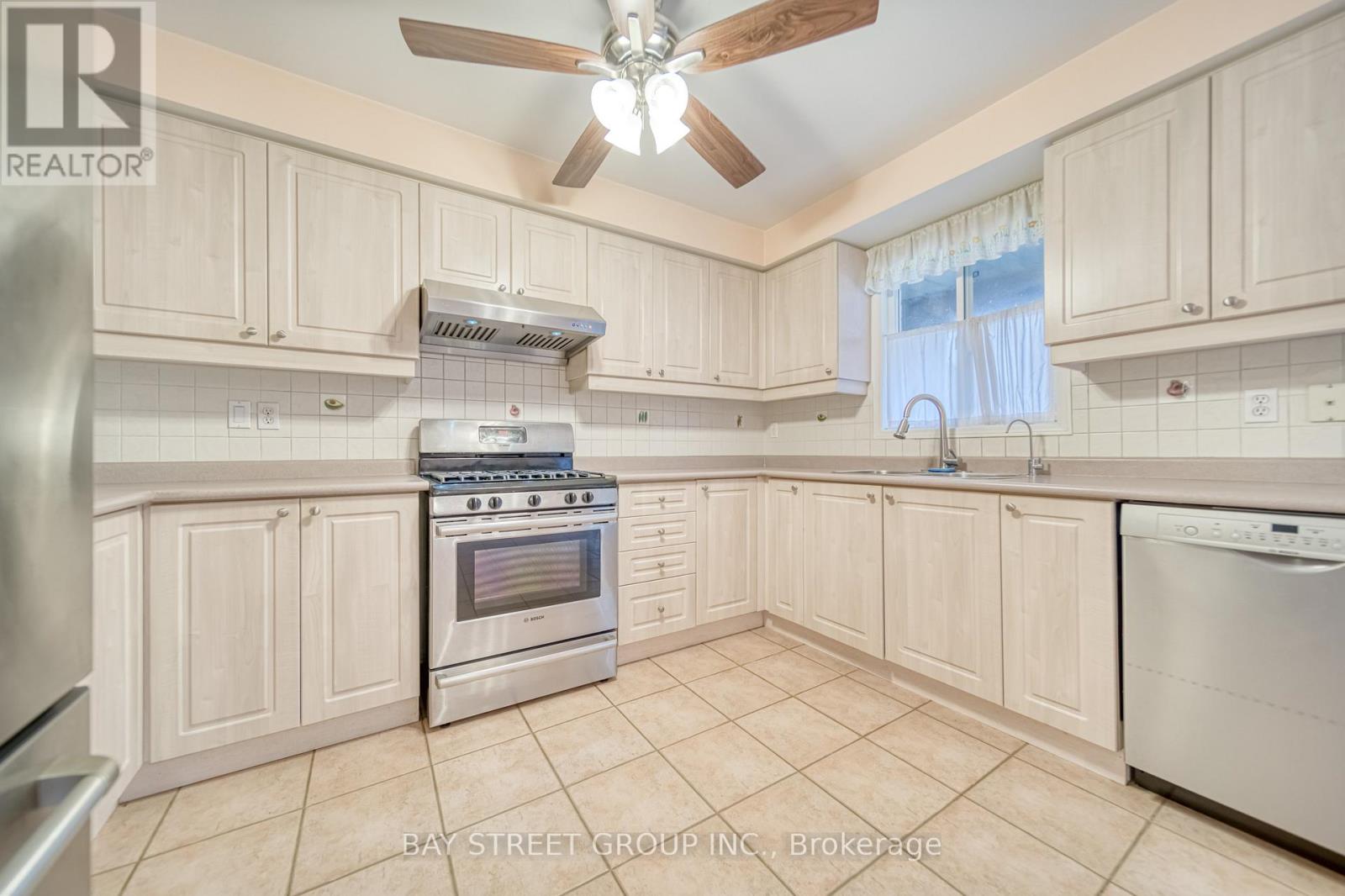 A kitchen with a stove top oven and a dishwasher.