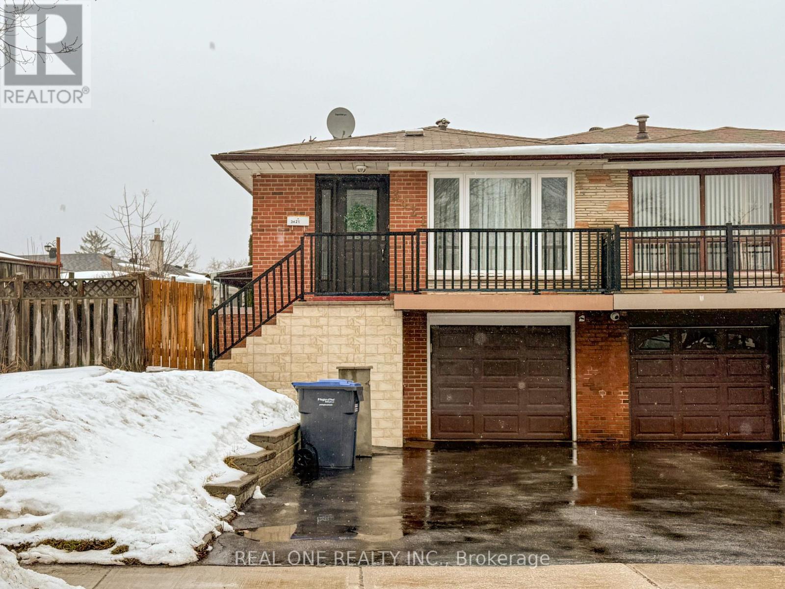 A house with a snow bank in front of it.